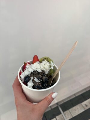 A nutritious yogurt cup topped with fresh fruits, chia seeds, and coconut flakes.