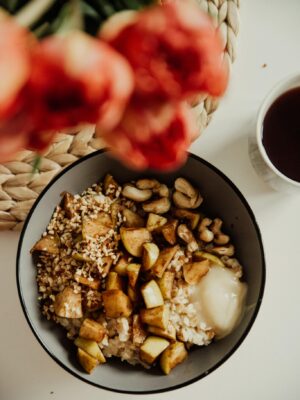 Delicious vegan breakfast bowl with oatmeal, nuts, and fruits, perfect for a healthy meal.